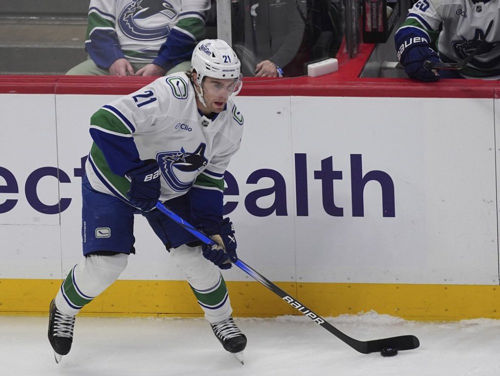 Vancouver Canucks left wing Nils Hoglander (21) in the first period of an NHL hockey game Thursday, April 10, 2025, in Denver. (AP Photo/David Zalubowski)