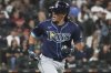 Tampa Bay Rays' Tristan Gray reacts as he rounds the bases after hitting a solo home run during the seventh inning of a baseball game against the Chicago White Sox in Chicago, Tuesday, Sept. 9, 2025. (AP Photo/Nam Y. Huh)