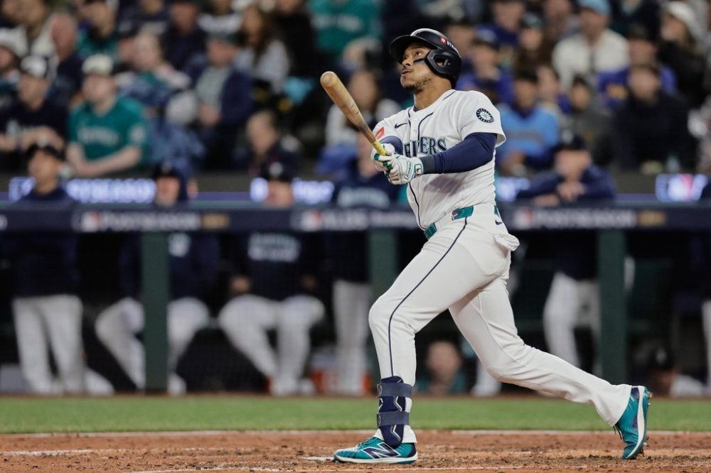 Seattle Mariners' Jorge Polanco watches the ball after hitting a solo home run during the sixth inning in Game 2 of baseball's American League Division Series against the Detroit Tigers, Sunday, Oct. 5, 2025, in Seattle. (AP Photo/John Froschauer)