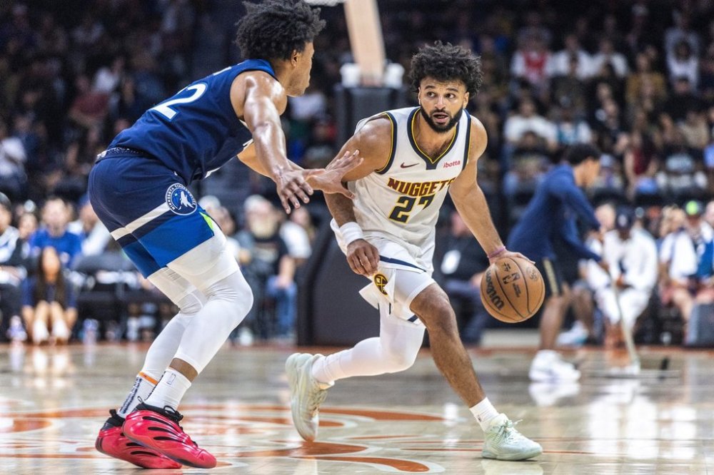 Minnesota Timberwolves guard Jaylen Clark, left, defends Denver Nuggets guard Jamal Murray (27) during the first half of a preseason NBA basketball game Saturday, Oct. 4, 2025, in San Diego. (AP Photo/Tony Ding)