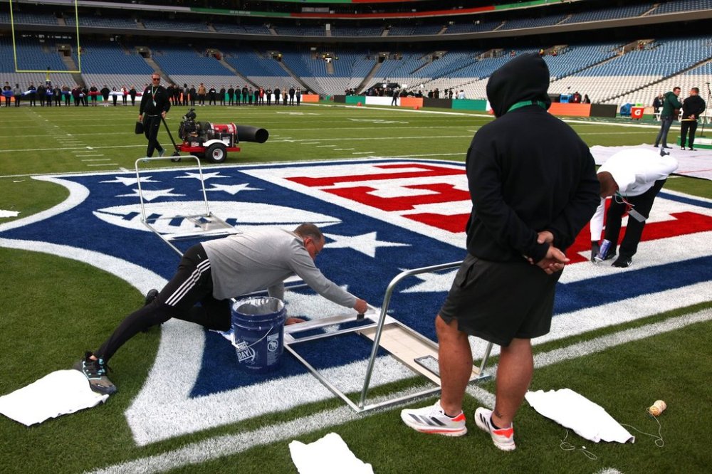 Workers put the final touch on the NFL logo before the start of the NFL football game between Minnesota Vikings and Pittsburgh Steelers at Croke Park stadium in Dublin, Sunday, Sept. 28, 2025.(AP Photo/Ian Walton)