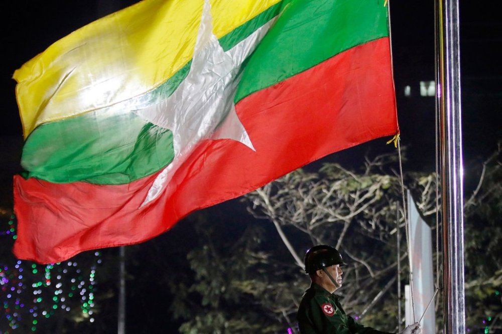 FILE - A Myanmar military soldier hoists a national flag during a ceremony to mark the 69th anniversary of Independence Day in Yangon, Myanmar on Jan. 4, 2017. (AP Photo, File)
