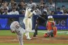 Los Angeles Dodgers' Shohei Ohtani, second from left, heads hits a solo home run as San Francisco Giants relief pitcher Joel Peguero, left, and catcher Patrick Bailey watch during the sixth inning of a baseball game, Saturday, Sept. 20, 2025, in Los Angeles. (AP Photo/Mark J. Terrill)