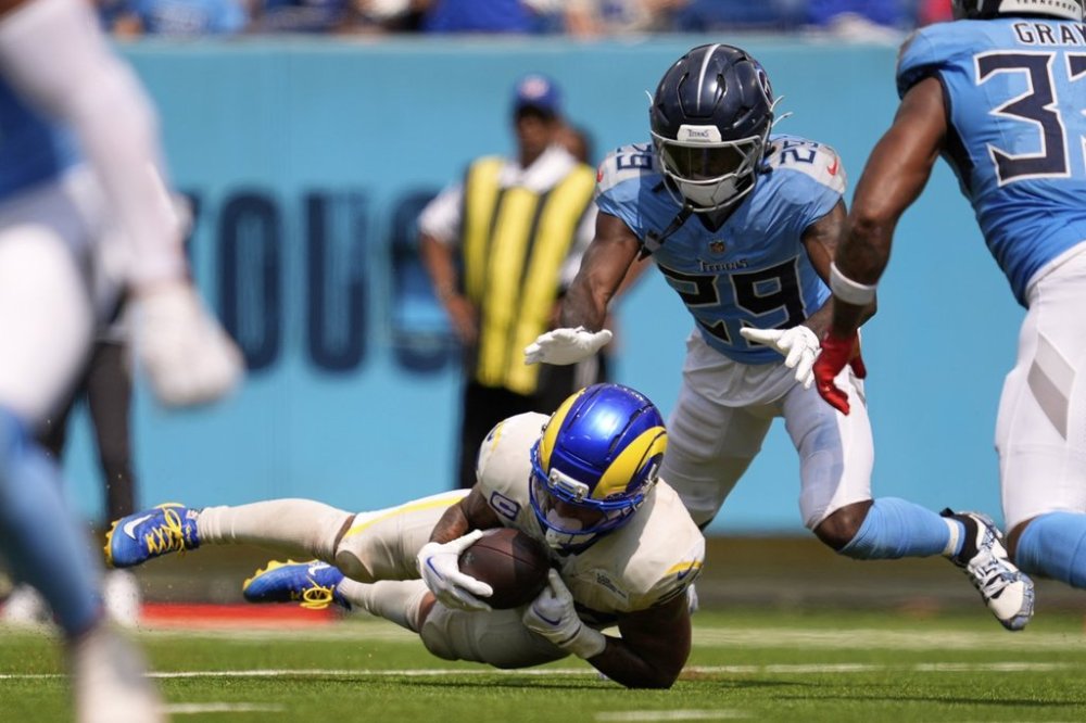 Los Angeles Rams running back Kyren Williams, below, makes a catch before being tackled by Tennessee Titans cornerback Jarvis Brownlee Jr. during the second half of an NFL football game Sunday, Sept. 14, 2025, in Nashville, Tenn. (AP Photo/George Walker IV)