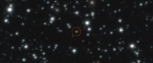 This image provided by the European Southern Observatory shows a powerful explosion, orange dot at the center of the image, that repeated several times over the course of a day, The image, taken with ESO's Very Large Telescope (VLT), allowed astronomers to determine that the explosion didn't take place in the Milky Way but in another galaxy. (European Southern Observatory via AP)