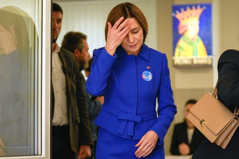 Moldova's President Maia Sandu exits a voting station after casting her vote during a parliamentary election, in Chisinau, Moldova, Sunday, Sept. 28, 2025. (AP Photo/Vadim Ghirda)