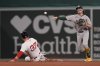 Athletics shortstop Jacob Wilson turns a double play on the force out of Boston Red Sox Nathaniel Lowe on a grounder by Carlos Narváez in the fourth inning of a baseball game, Wednesday, Sept. 17, 2025, in Boston. (AP Photo/Robert F. Bukaty)