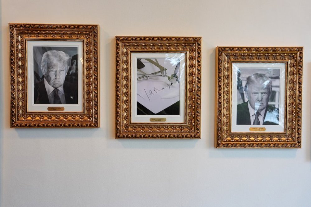 Framed images of President Donald Trump and former President Joe Biden's autopen signature, center, appear on the Presidential Walk of Fame on the colonnade of the White House, Thursday, Sept. 25, 2025, in Washington. (AP Photo/Evan Vucci)