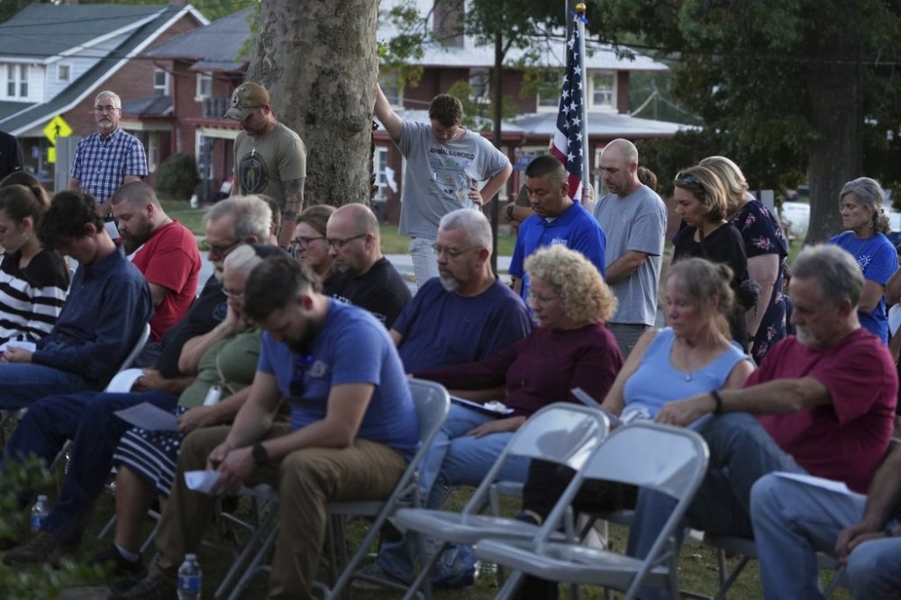 Attendees react during a vigil at Spring Grove Alliance church Thursday, Sept. 18, 2025, in Spring Grove, Pa., after multiple police officers were shot and killed. (AP Photo/Matt Slocum)
