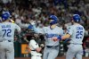 Los Angeles Dodgers' Andy Pages, center, celebrates his two-run home run against the Arizona Diamondbacks with Dodgers' Miguel Rojas (72) and Tommy Edman (25) during the fourth inning of a baseball game Wednesday, Sept. 24, 2025, in Phoenix. (AP Photo/Ross D. Franklin)