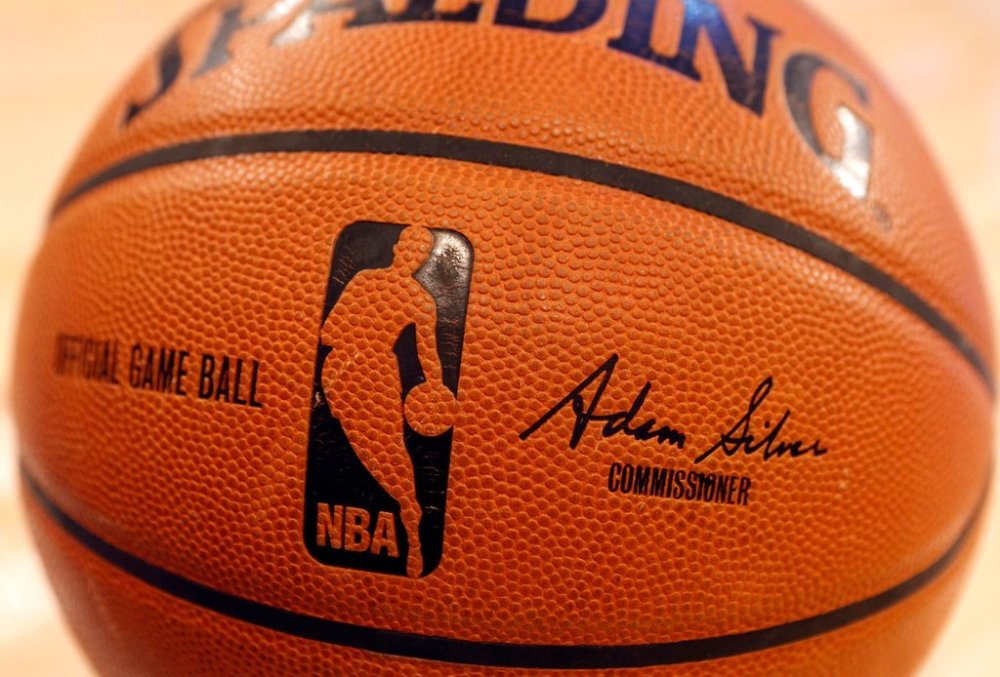 FILE - An NBA logo is seen on an official game ball before a basketball game, Feb. 1, 2014, in New York. (AP Photo/Jason DeCrow, file)