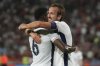 England's Marc Guehi, left, celebrates with England's Harry Kane after scoring his side's fourth goal during the World Cup Group K qualifying soccer match between Serbia and England, at the Rajko Mitic Stadium in Belgrade, Serbia, Tuesday, Sept. 9, 2025. (AP Photo/Darko Vojinovic)