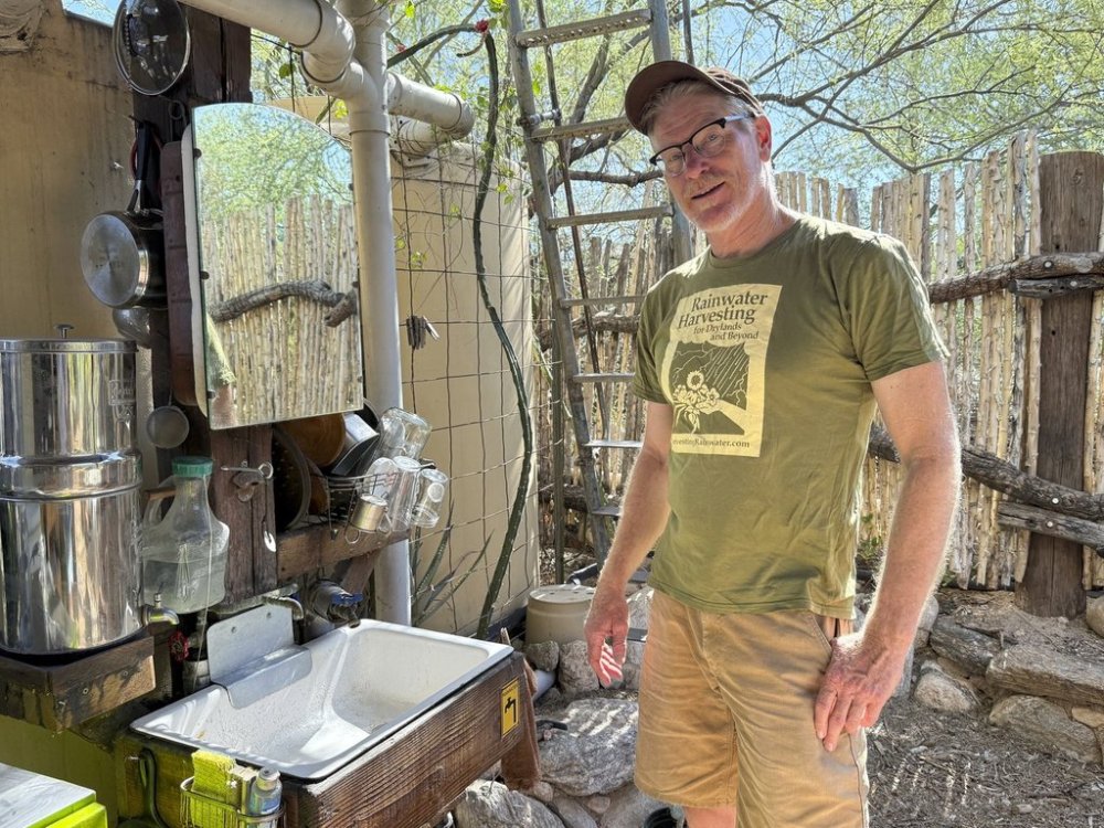 Rainwater harvesting expert Brad Lancaster poses at his outdoor home kitchen in Tucson, Ariz., on Aug. 1, 2025. (Anita Snow via AP)