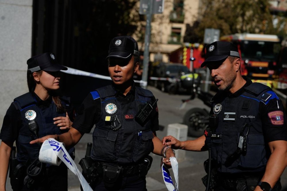 Police rope off an area as emergency personnel respond to the scene of a building collapse in Madrid, Spain, on Tuesday, Oct. 7, 2025. (AP Photo/Manu Fernandez)