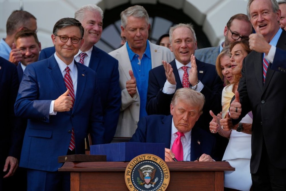 FILE - President Donald Trump signs his signature bill of tax breaks and spending cuts at the White House, July 4, 2025, in Washington, surrounded by members of Congress. (AP Photo/Julia Demaree Nikhinson, File)