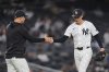 New York Yankees pitcher Luke Weaver, right, hands the ball to manager Aaron Boone as he leaves during the ninth inning of a baseball game against the Detroit Tigers Wednesday, Sept. 10, 2025, in New York. (AP Photo/Frank Franklin II)