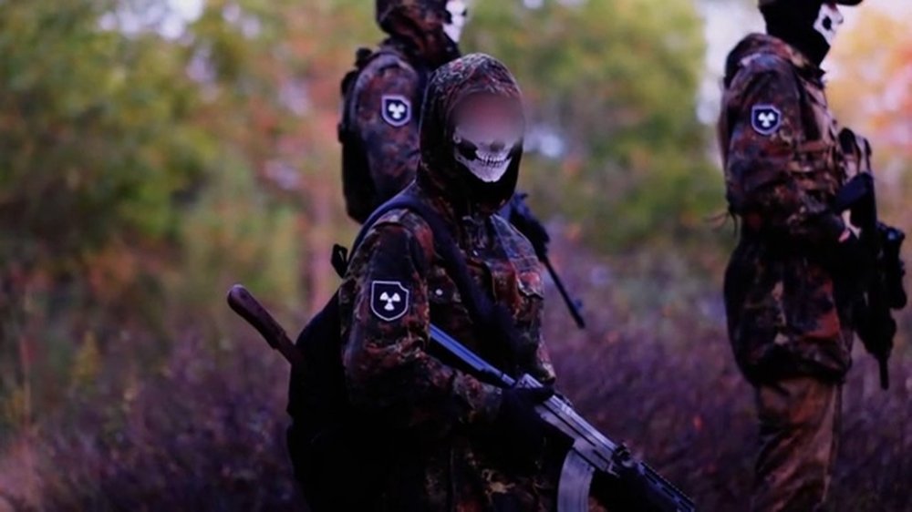 This still image taken from video, released as evidence in a Superior Court trial, shows armed and masked individuals in combat gear who are part of the neo-Nazi group Atomwaffen Division. THE CANADIAN PRESS/Handout