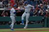 Texas Rangers' Alejandro Osuna, left reacts with third base coach Tony Beasley after hitting a three-run home run off Cleveland Guardians starting pitcher Slade Cecconi during the first inning of a baseball game, Friday, Sept. 26, 2025, in Cleveland. (AP Photo/Phil Long)