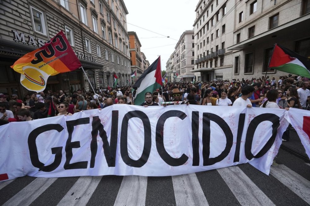 People hold a banner reading