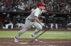 Philadelphia Phillies' J.T. Realmuto starts to run after hitting a single against the Arizona Diamondbacks in the eighth inning of a baseball game, Saturday, Sept. 20, 2025, in Phoenix. (AP Photo/Rick Scuteri)