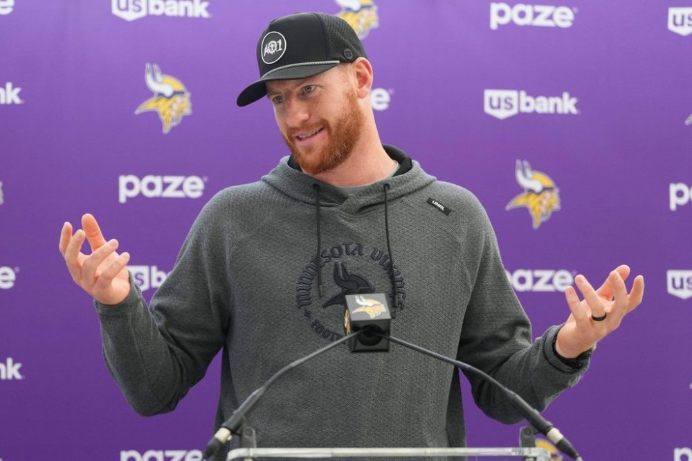 Minnesota Vikings quarterback Carson Wentz speaks during a press conference at NFL football practice at Hanbury Manor in Ware, England, Wednesday, Oct. 1, 2025. The Vikings play the Cleveland Browns in London on Sunday. (AP Photo/Kirsty Wigglesworth)