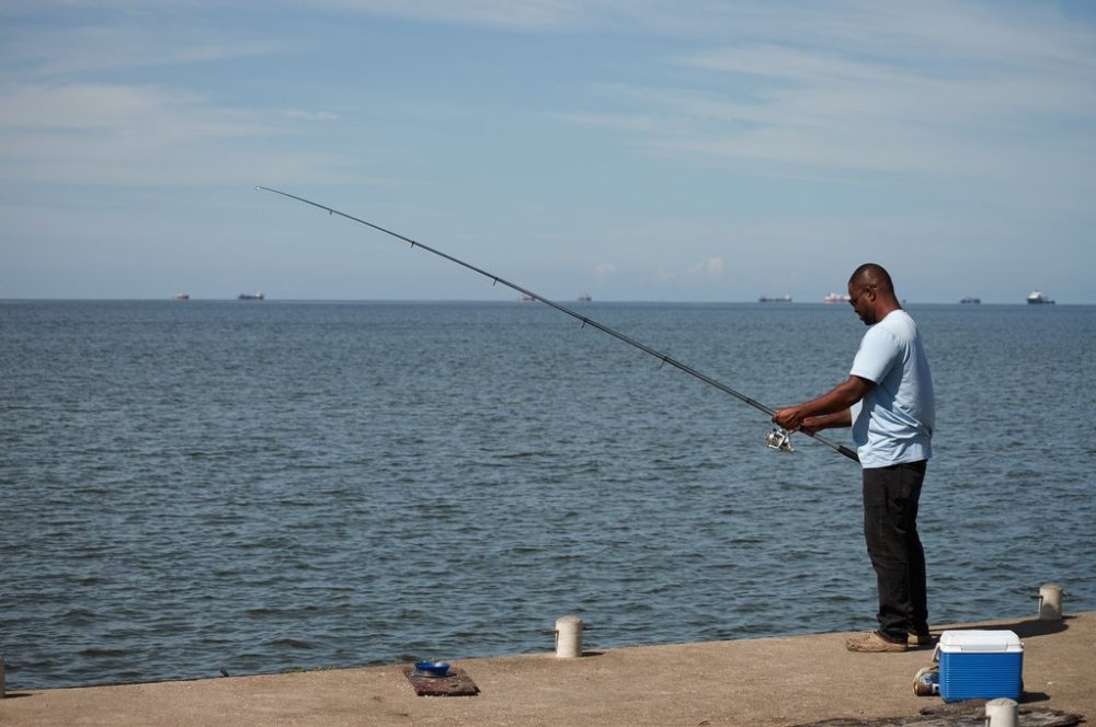 A man fishes in Cocorite, Trinidad and Tobago, Friday, Oct. 3, 2025. (AP Photo/Anselm Gibbs)