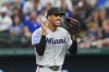 Miami Marlins starting pitcher Eury Pérez celebrates while walking towards the dugout after striking out Texas Rangers' Jonah Heim during the fourth inning of a baseball game against the Texas Rangers on Sunday, Sept. 21, 2025, in Arlington, Texas. (AP Photo/Ronaldo Bolaños)