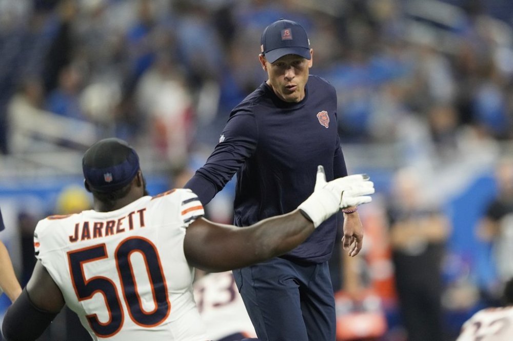 Chicago Bears coach Ben Johnson greets defensive end Grady Jarrett (50) before an NFL football game against the Detroit Lions in Detroit, Sunday, Sept. 14, 2025. (AP Photo/Ryan Sun)
