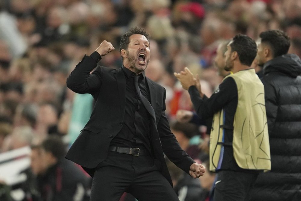 Atletico Madrid's head coach Diego Simeone celebrates after his player Marcos Llorente scored his side's opening goal during the Champions League opening phase soccer match between Liverpool and Atletico Madrid at Anfield stadium in Liverpool, England, Wednesday, Sept. 17, 2025. (AP Photo/Jon Super)