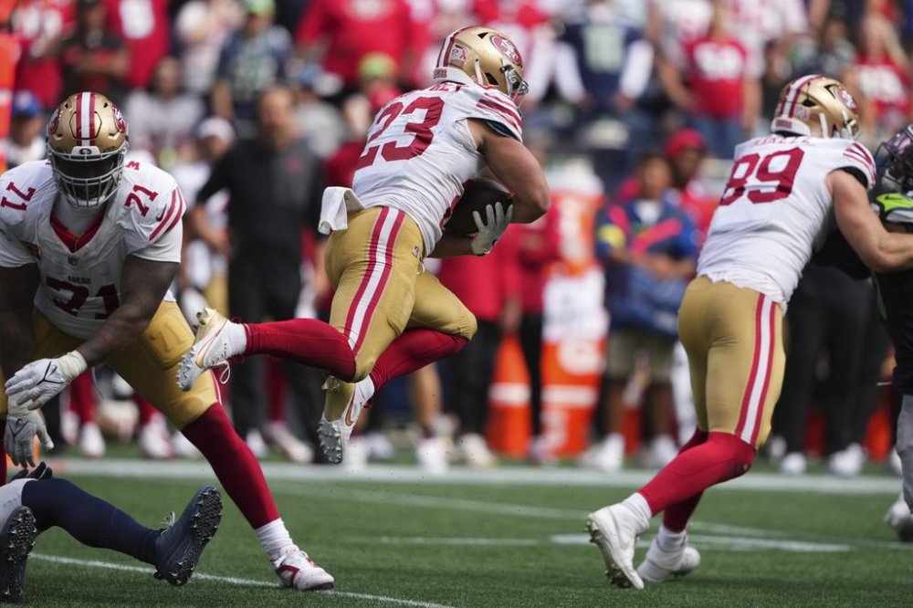 San Francisco 49ers running back Christian McCaffrey (23) carries the ball during the second half of an NFL football game against the Seattle Seahawks, Sunday, Sept. 7, 2025, in Seattle. (AP Photo/Lindsey Wasson)