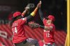 Cincinnati Reds' Austin Hays (12) and Elly De La Cruz (44) celebrate a victory over the St. Louis Cardinals following a baseball game against the St. Louis Cardinals Wednesday, Sept. 17, 2025, in St. Louis. (AP Photo/Jeff Roberson)