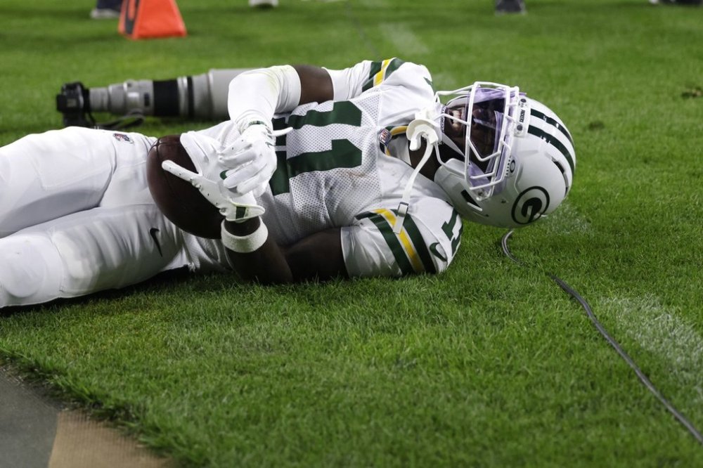 Green Bay Packers wide receiver Jayden Reed reacts after being injured during the first half of an NFL football game against the Washington Commanders Thursday, Sept. 11, 2025, in Green Bay, Wis. (AP Photo/Matt Ludtke)
