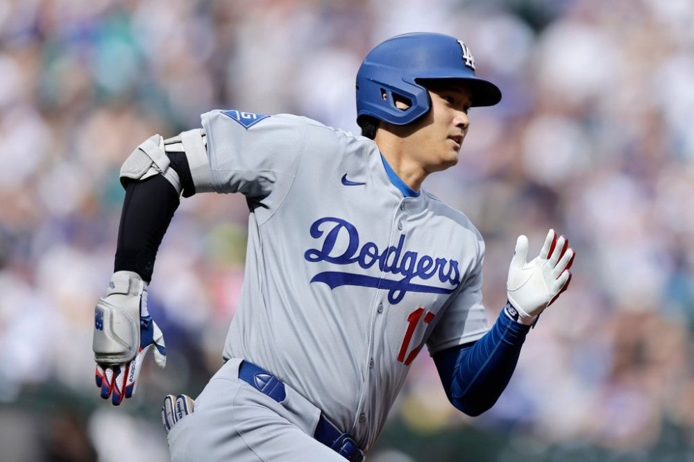 Los Angeles Dodgers Shohei Ohtani runs toward first base as he doubles against the Seattle Mariners during a baseball game, Sunday, Sept. 28, 2025, in Seattle. (AP Photo/John Froschauer)