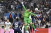 PSG's goalkeeper Lucas Chevalier, centre, in action during the French League One soccer match between Marseille and Paris Saint-Germain at Orange Velodrome in Marseille, France, Monday, Sept. 22, 2025. (AP Photo/Philippe Magoni)