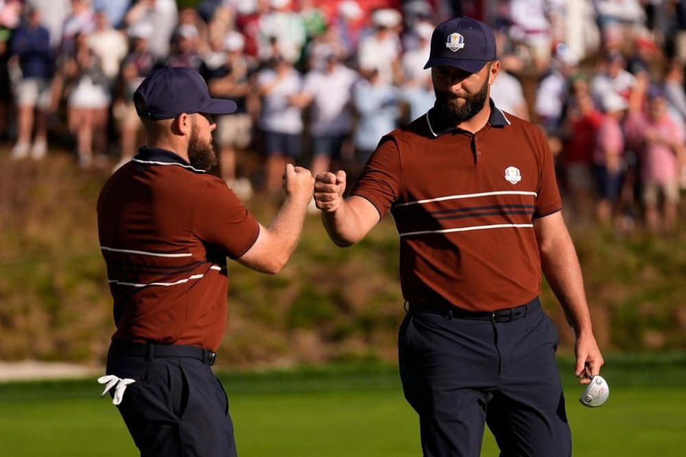 Europe's Tyrrell Hatton celebrates with Jon Rahm on the sixth hole at Bethpage Black golf course during the Ryder Cup golf tournament, Saturday, Sept. 27, 2025, in Farmingdale, N.Y. (AP Photo/Robert Bukaty)