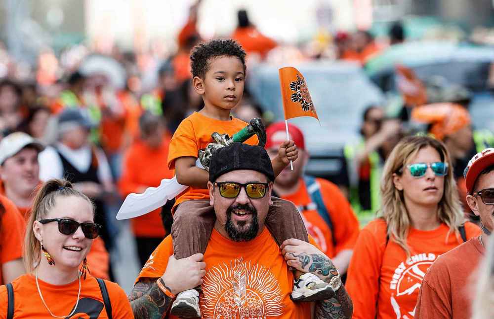 People take part in the Orange Shirt Healing Walk and Powwow in Winnipeg Tuesday.