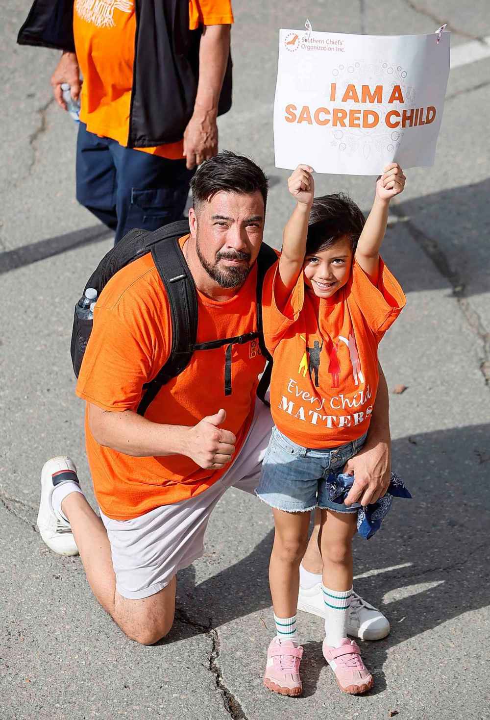 People take part in the Orange Shirt Healing Walk and Powwow in Winnipeg Tuesday.