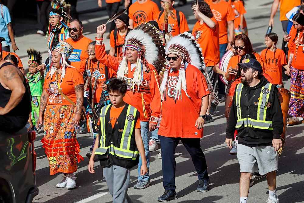 People take part in the Orange Shirt Healing Walk and Powwow in Winnipeg Tuesday.
