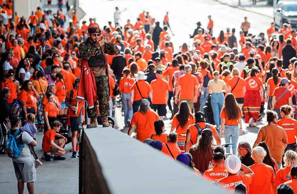 People take part in the Orange Shirt Healing Walk and Powwow in Winnipeg Tuesday.