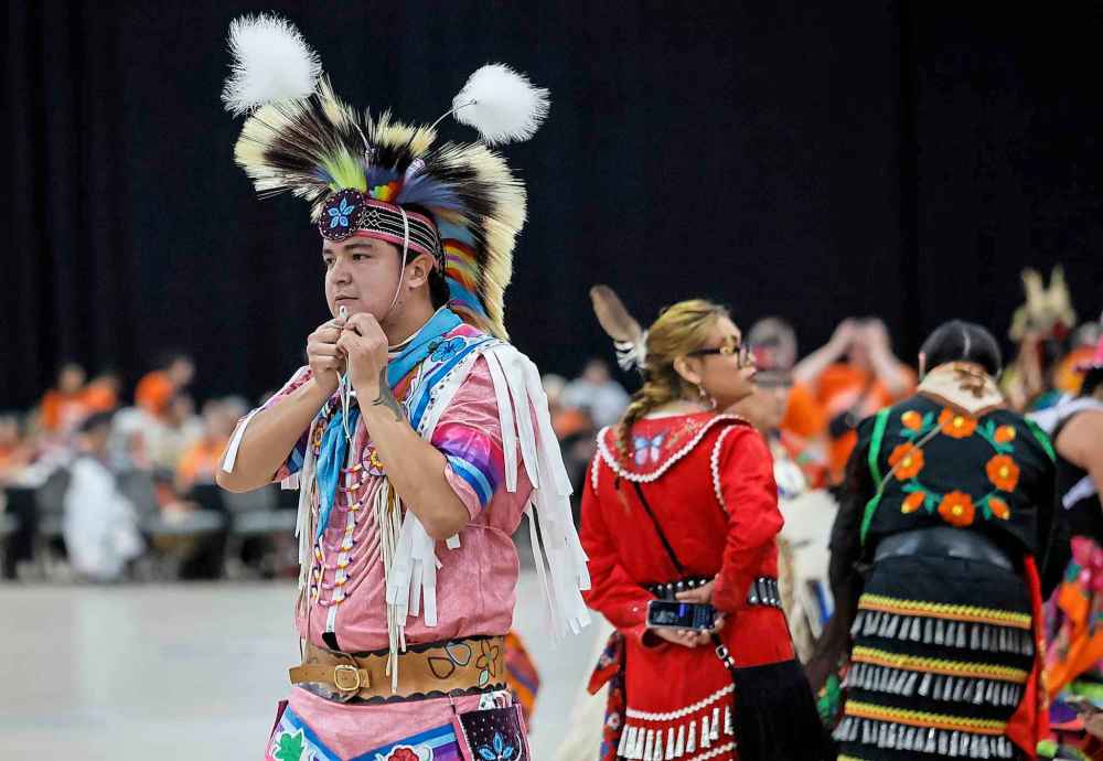 People take part in the Orange Shirt Healing Walk and Powwow.