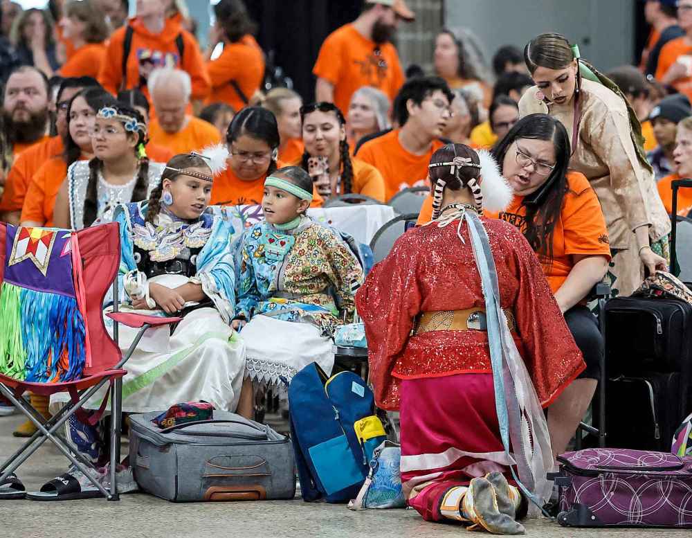 People take part in the Orange Shirt Healing Walk and Powwow.