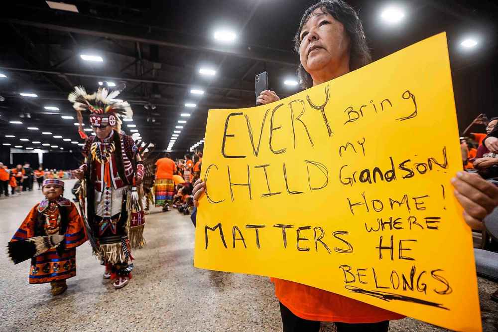 People take part in the Orange Shirt Healing Walk and Powwow.