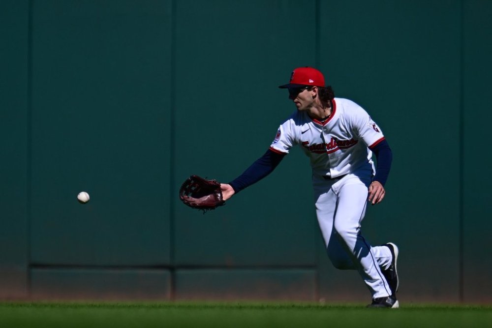 Cleveland Guardians center fielder Chase DeLauter misses a ball hit by Detroit Tigers' Gleyber Torres for a fielding error in the first inning of Game 2 of the American League Wild Card baseball playoff series in Cleveland, Wednesday, Oct. 1, 2025. (AP Photo/David Dermer)