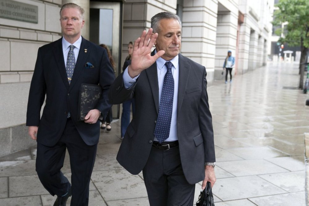 Retired Adm. Robert P. Burke, 63, right, walks out of the federal courthouse after being sentenced to six years in prison for his conviction on corruption charges, Tuesday, Sept. 16, 2025, in Washington. (AP Photo/Jose Luis Magana)