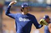 FILE - Los Angeles Dodgers pitcher Roki Sasaki warms up before a baseball game against the Toronto Blue Jays, Aug. 9, 2025, in Los Angeles. (AP Photo/Jessie Alcheh, File)