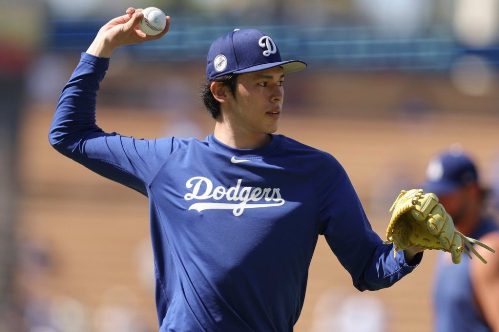 FILE - Los Angeles Dodgers pitcher Roki Sasaki warms up before a baseball game against the Toronto Blue Jays, Aug. 9, 2025, in Los Angeles. (AP Photo/Jessie Alcheh, File)