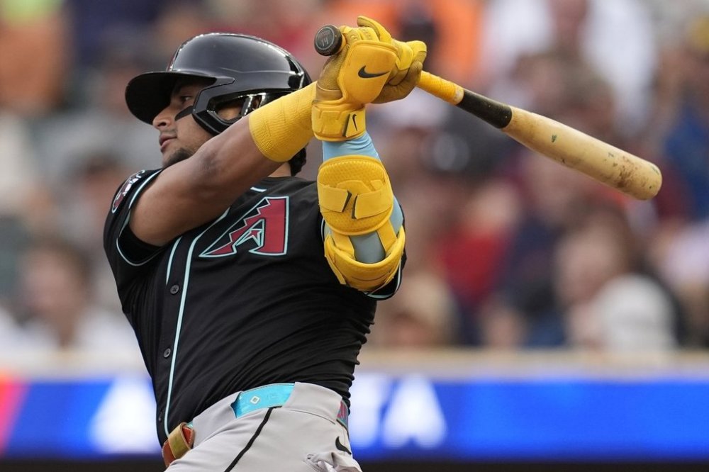 Arizona Diamondbacks' Gabriel Moreno (14) hits a single in the first inning of a baseball game against the Minnesota Twins, Saturday, Sept. 13, 2025, in Minneapolis. (AP Photo/Mike Stewart)