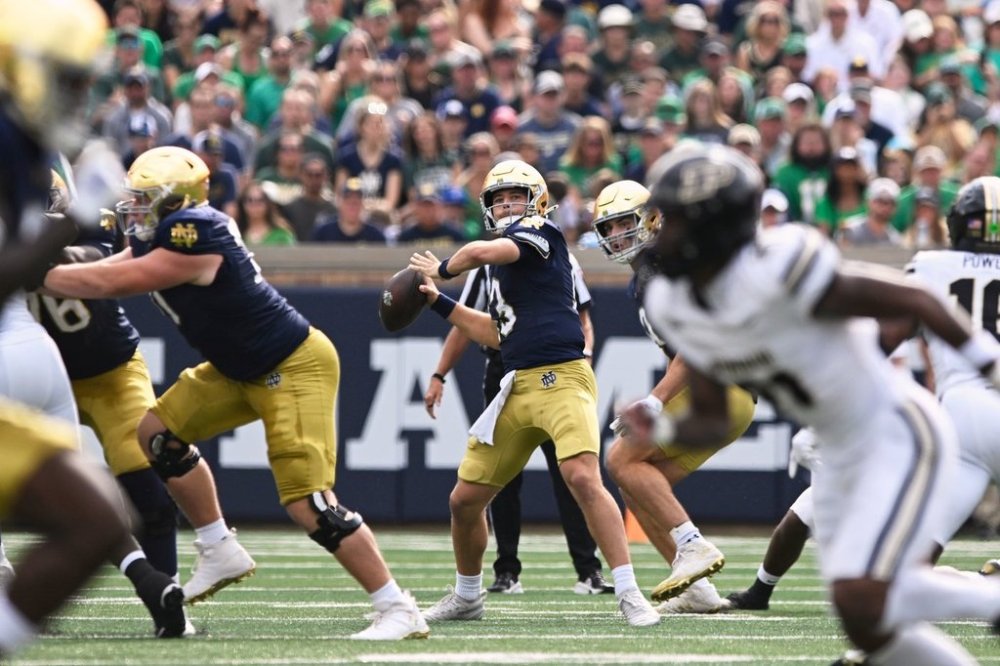 Notre Dame quarterback CJ Carr (13) throws a 66 yard touchdown pass to wide receiver Malachi Fields during the first quarter of an NCAA football game against Purdue, Saturday, Sept. 20, 2025, in South Bend, Ind. (AP Photo/Paul Beaty)