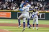Los Angeles Dodgers first base Enrique Hernández (8) and Miquel Rojas, right, celebrate after the Dodgers clinched the National League West title against the Arizona Diamondbacks during a baseball game at Chase Field Thursday, Sept. 25, 2025, in Phoenix. (AP Photo/Darryl Webb)