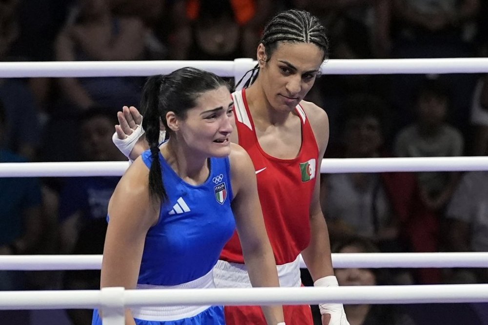 FILE - Algeria's Imane Khelif, right, looks at Italy's Angela Carini, following their women's 66kg preliminary boxing match at the 2024 Summer Olympics, Thursday, Aug. 1, 2024, in Paris, France. (AP Photo/John Locher, File)